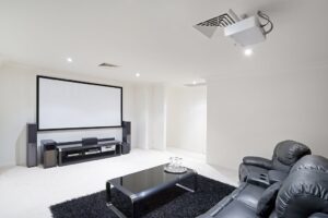 Modern bright home theater Room with black leather recliner chairs